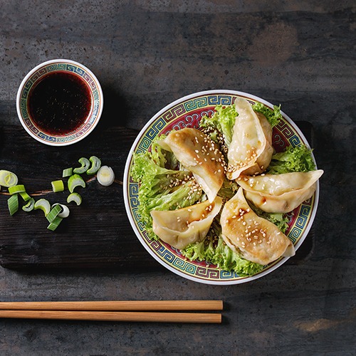 gyoza potsticker recipe web Plate of gyoza potsticker with bowl of soy sauce and chopsticks
